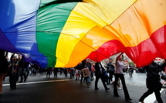 Gay rights activists hold a rainbow flag during a rally to support same-sex marriage in central Sydney
